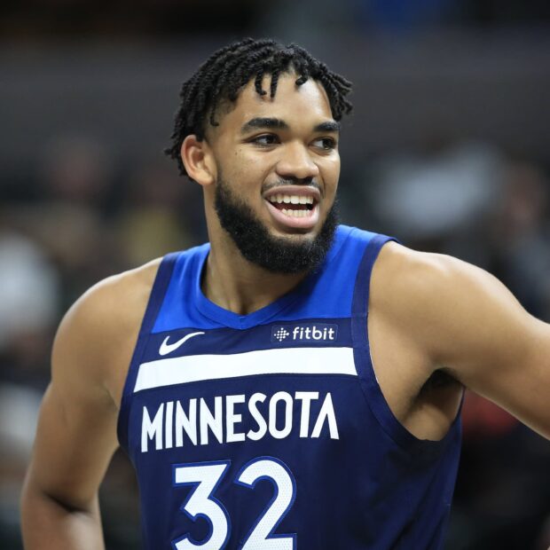 Karl Anthony Towns smiling during a basketball game in Minnesota jersey number 32