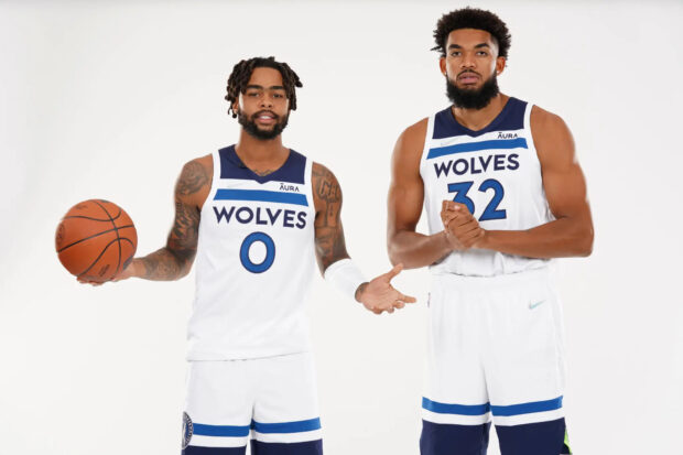 Karl Anthony Towns standing with a teammate in Wolves basketball uniforms