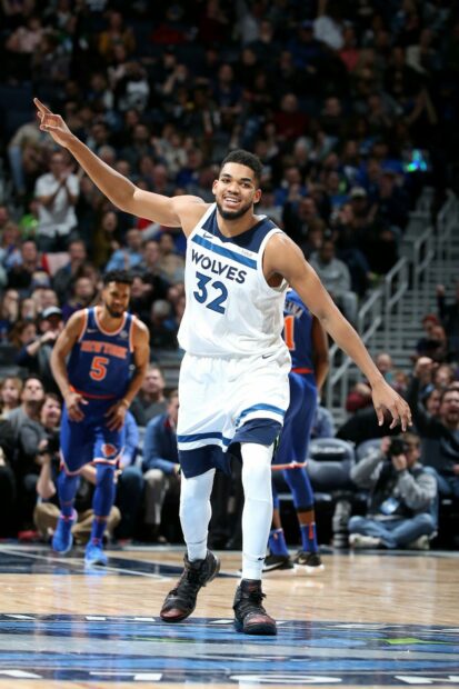 Karl Anthony Towns celebrates on the basketball court during a Wolves game