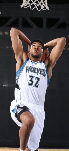 Karl Anthony Towns preparing to dunk during a basketball game