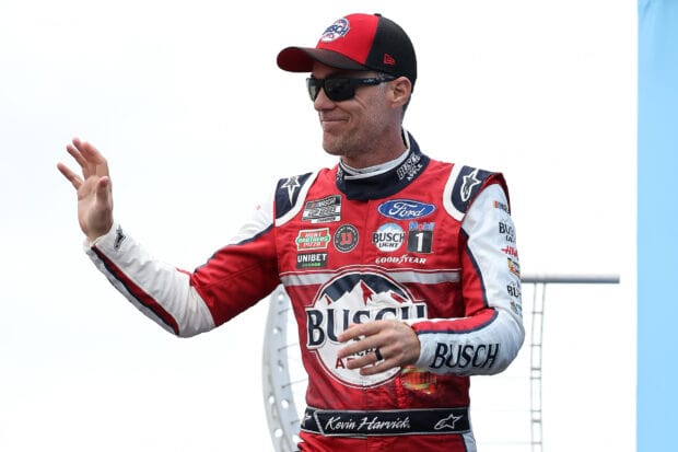 Kevin Harvick is waving while wearing his red racing suit with sponsor logos, HD Desktop Wallpaper