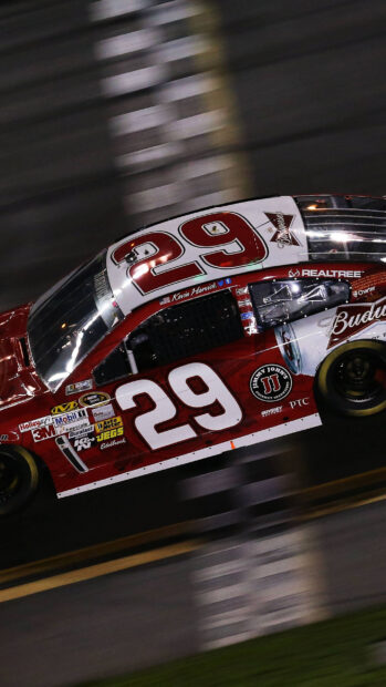 Kevin Harvick race car with number 29 speeds on the track at night, 2K Mobile Wallpaper