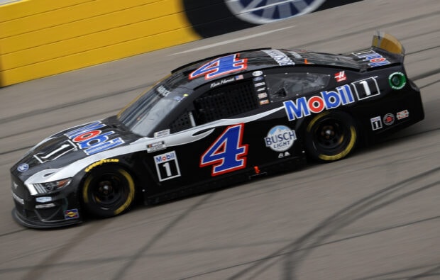 Kevin Harvick is driving a black racing car with Mobil 1 logo on the track, 2K Desktop Wallpaper