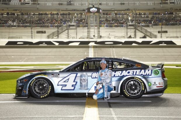 Kevin Harvick is posing beside his racing car at Daytona racetrack, HD Desktop Wallpaper