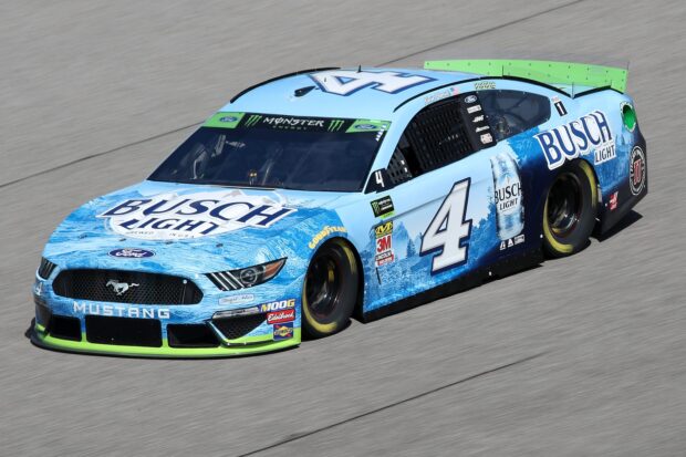 A blue Kevin Harvick car speeds on the racetrack during a NASCAR event, 2K Desktop Wallpaper