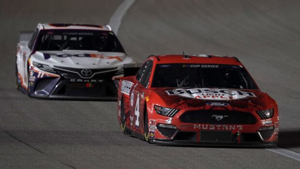 Kevin Harvick racing car is leading another car on the night race track, 4K Desktop Wallpaper