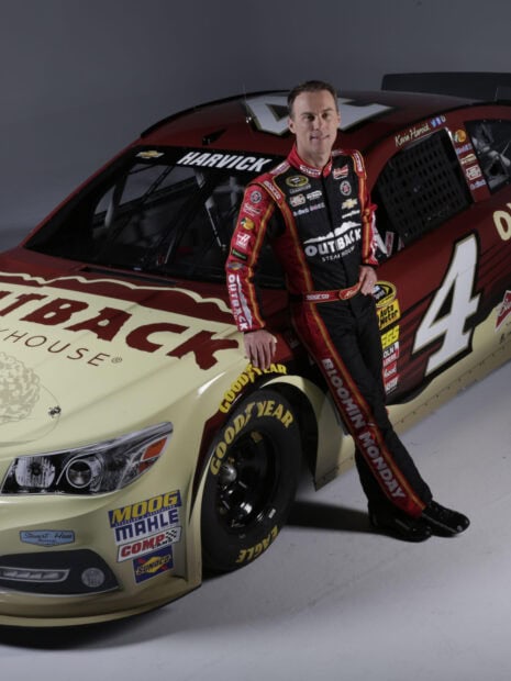 Kevin Harvick is leaning on his race car with sponsor logos visible, HD Desktop Wallpaper