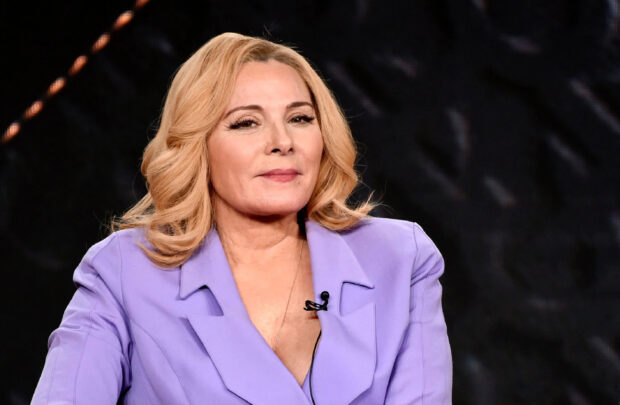 Kim Cattrall is dressed in a purple blazer with styled blonde hair and a subtle smile, 2K Desktop Wallpaper