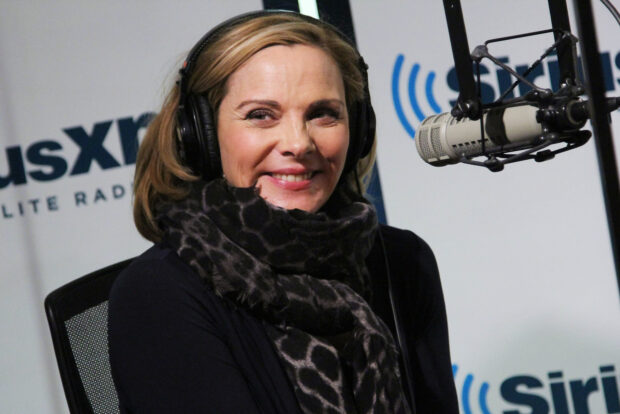 Kim Cattrall is smiling while wearing headphones at a SiriusXM radio studio, HD Desktop Wallpaper
