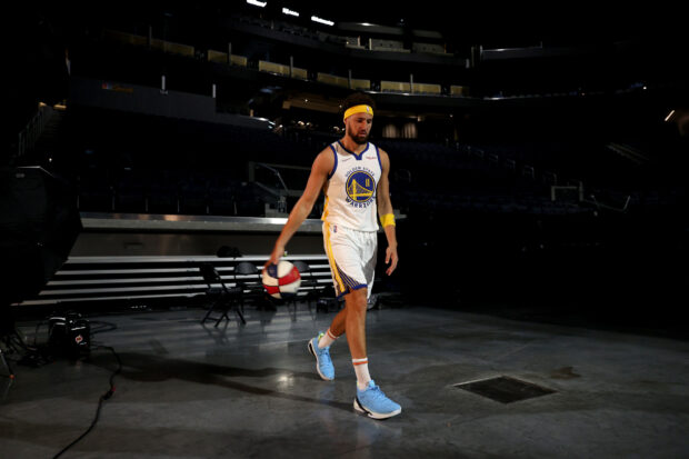 Klay Thompson is walking on a basketball court holding a ball, HD Desktop Wallpaper