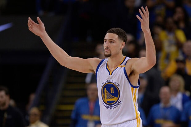 Klay Thompson celebrates with arms raised during a basketball game, 2K Desktop Wallpaper