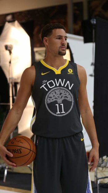 Klay Thompson stands holding a basketball wearing a black The Town jersey, HD Mobile Wallpaper