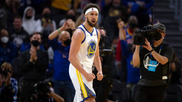 Klay Thompson celebrates during a basketball game with fans and cameraman nearby, HD Desktop Wallpaper