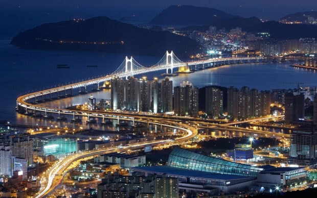 Night view of Korea cityscape featuring illuminated bridges and modern buildings