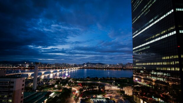 Night view of Korea city skyline with Han River and illuminated bridge