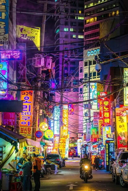 Vibrant Korea street scene with neon signs and people at night