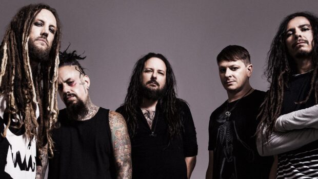 Korn band members posing together in a studio setting