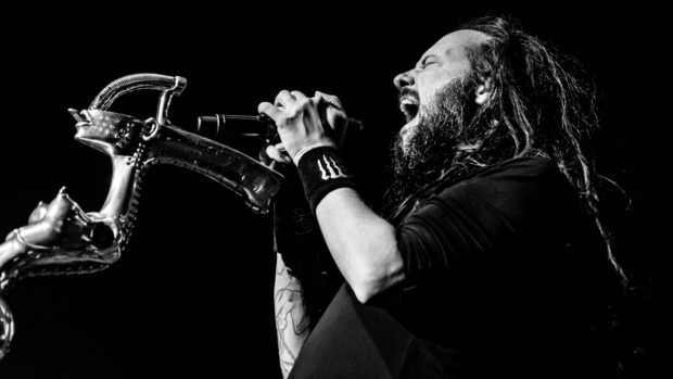 The lead singer of Korn passionately performing with unique microphone stand on stage