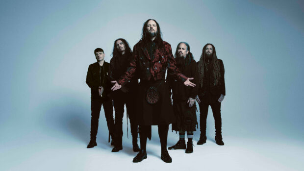 Korn band members posing together in a studio setting with artistic lighting