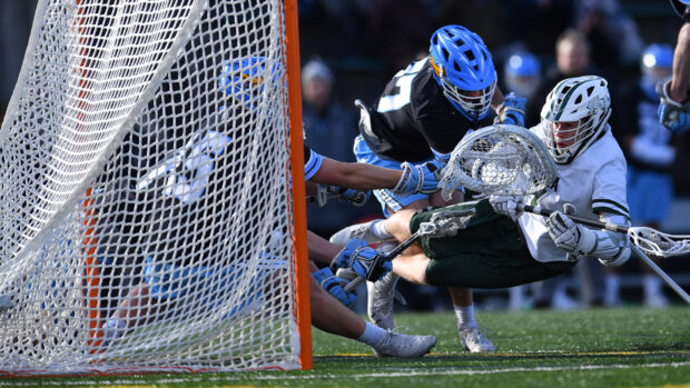 A lacrosse player defends the goal against an opponent during a match, HD Desktop Wallpaper