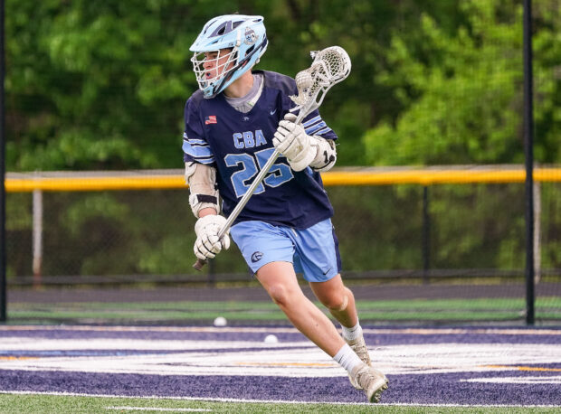 A lacrosse player is running on the field during a match, holding a lacrosse stick, Lacrosse Wallpapers, HD Desktop Wallpaper