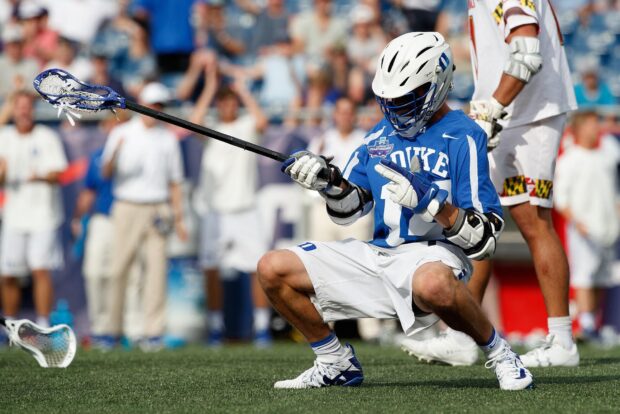 A lacrosse player in blue celebrates on the field during a game, HD Desktop Wallpaper