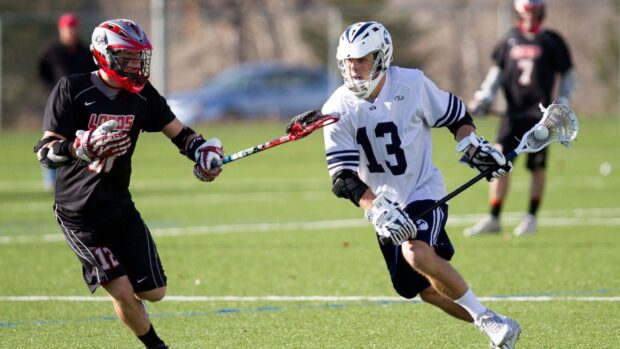 Two lacrosse players compete intensely during a game, HD Desktop Wallpaper