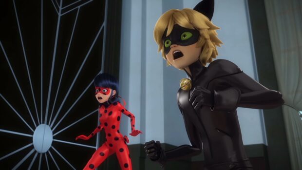 Ladybug and Cat Noir in action pose inside a building with surprised expressions
