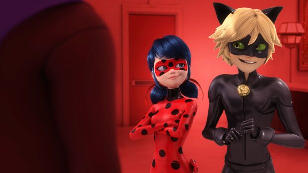 Ladybug and Cat Noir standing side by side in a red room with confident expressions