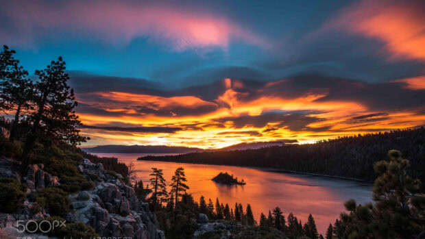 A vibrant sunset over Lake Tahoe Emerald Bay surrounded by forested hills, HD Desktop Wallpaper
