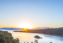 The sun rises over Lake Tahoe Emerald Bay surrounded by pine trees and mountains, HD Desktop Wallpaper