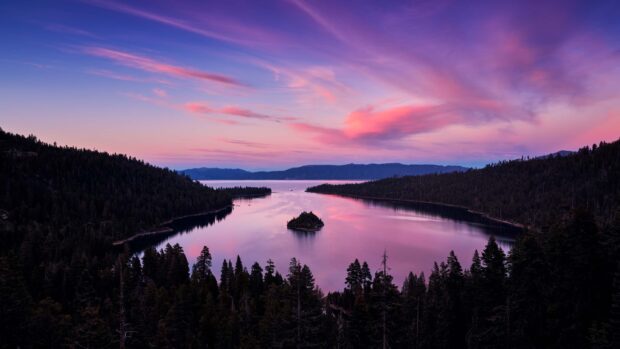 The calm waters of Lake Tahoe Emerald Bay reflect the vibrant colors of the sunset sky, 2K Desktop Wallpaper