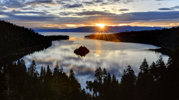 The sun sets over Lake Tahoe Emerald Bay surrounded by pine trees and mountains, HD Desktop Wallpaper