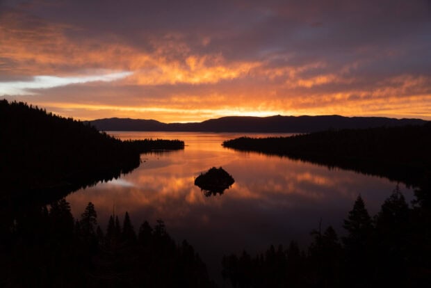 Lake Tahoe Emerald Bay reflects the vibrant colors of the sunset over calm waters, HD Desktop Wallpaper
