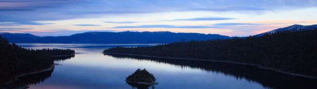 Lake Tahoe Emerald Bay shows calm water and surrounding mountains at twilight, 4K Desktop Wallpaper