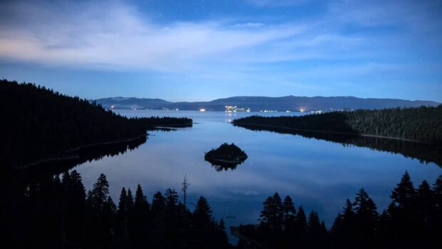 A peaceful view of Lake Tahoe Emerald Bay with calm water and silhouetted trees at dusk, HD Desktop Wallpaper