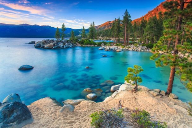 A calm and clear lake Tahoe Emerald Bay surrounded by pine trees and sandy shores, HD Desktop Wallpaper
