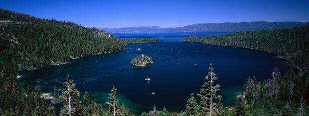 A panoramic view of Lake Tahoe Emerald Bay surrounded by forest and mountains, 2K Desktop Wallpaper