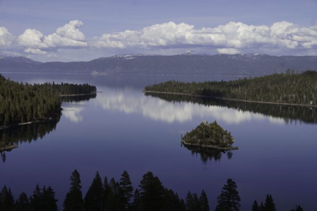 A clear view of Lake Tahoe Emerald Bay with calm water and cloudy sky, 2K Desktop Wallpaper