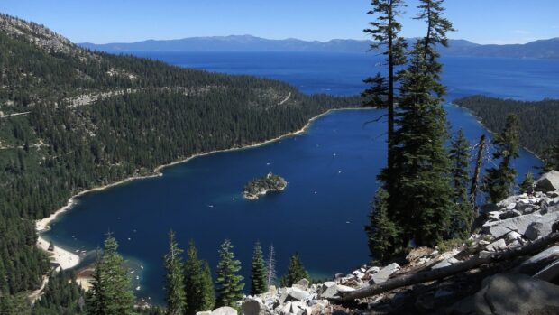 A scenic view of Lake Tahoe Emerald Bay surrounded by pine trees and mountains, HD Desktop Wallpaper