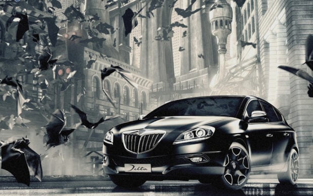 A black Lancia Delta car is surrounded by flying bats in an urban night setting, HD Desktop Wallpaper