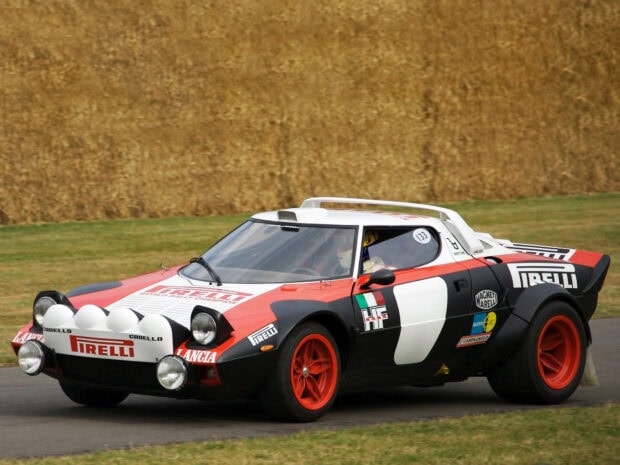 A Lancia racing car is driven on a track during a rally event, HD Desktop Wallpaper