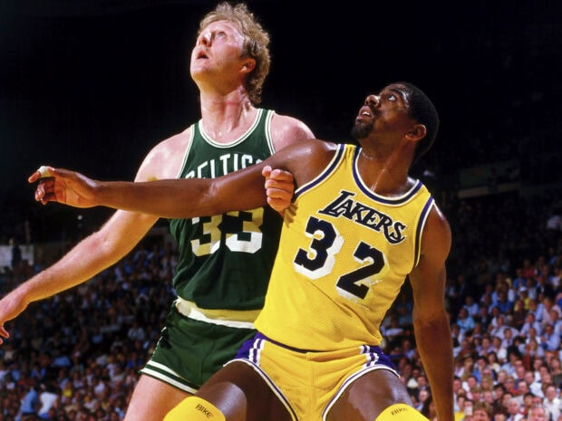 Larry Bird closely defending Magic Johnson in a basketball game, HD Desktop Wallpaper