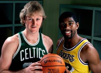 Larry Bird and Magic Johnson stand holding a basketball in a locker room, HD Desktop Wallpaper
