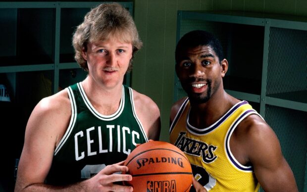 Larry Bird and Magic Johnson stand holding a basketball in a locker room, HD Desktop Wallpaper