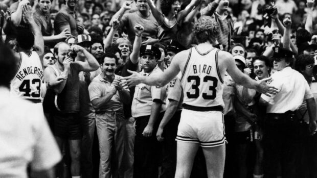 Larry Bird greets enthusiastic crowd while wearing number 33 basketball jersey, 2K Desktop Wallpaper