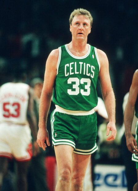 Larry Bird walks on the court during a basketball game wearing a Celtics uniform, 2K Mobile Wallpaper