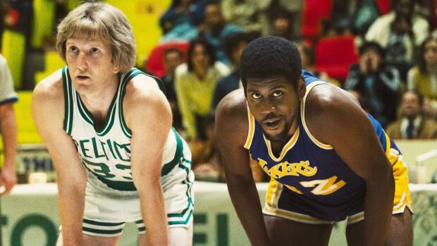 Larry Bird focused during a match with an opponent on the court, HD Desktop Wallpaper