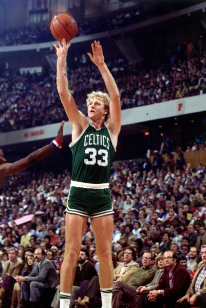 Larry Bird is shooting the ball during a crowded basketball game, HD Mobile Wallpaper