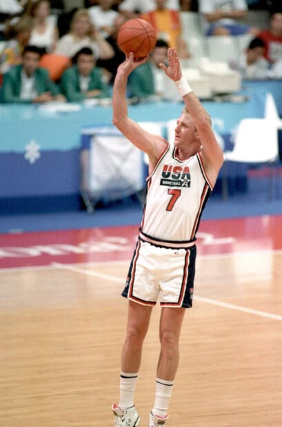 Larry Bird is taking a shot during a basketball game, HD Phone Wallpaper